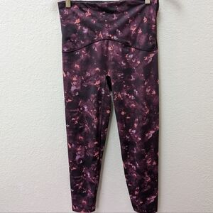 Spanx Booty Boost Leggings in a burgundy tie-dye pattern. Size Medium